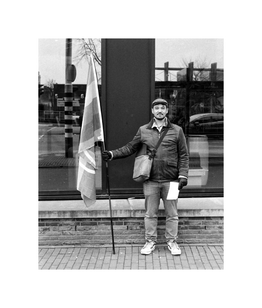 Standing upright, classic black and white, posed.